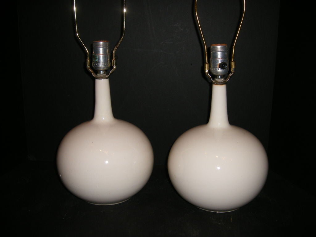 Pair of circa 1940's French creamy white porcelain table lamps.

Measurements:
Height of body: 10