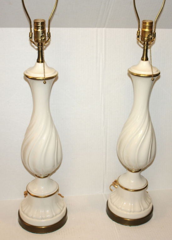 Pair of French circa 1940's porcelain table lamps with gilt details.

Measurements:
Height of body: 24?
Height to shade rest: 32?
