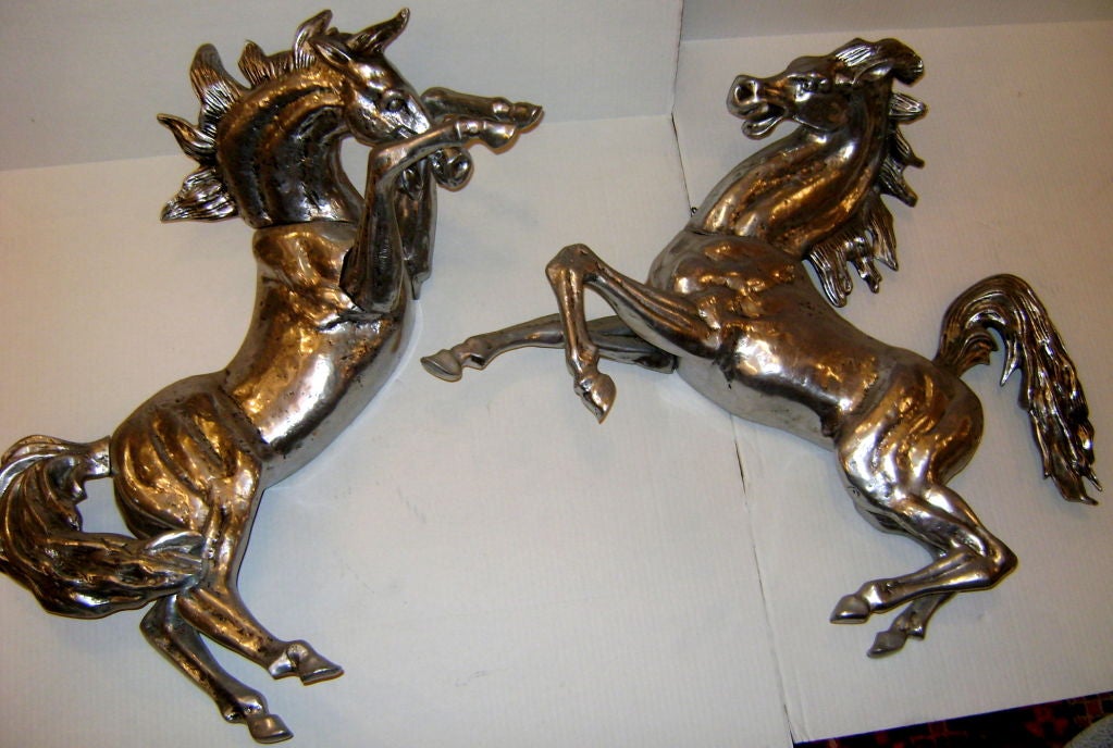 Pair of pewter horse shaped sconces with two interior lights each, which reflect back and come out of the sides.
Original patina.

Measures: 30