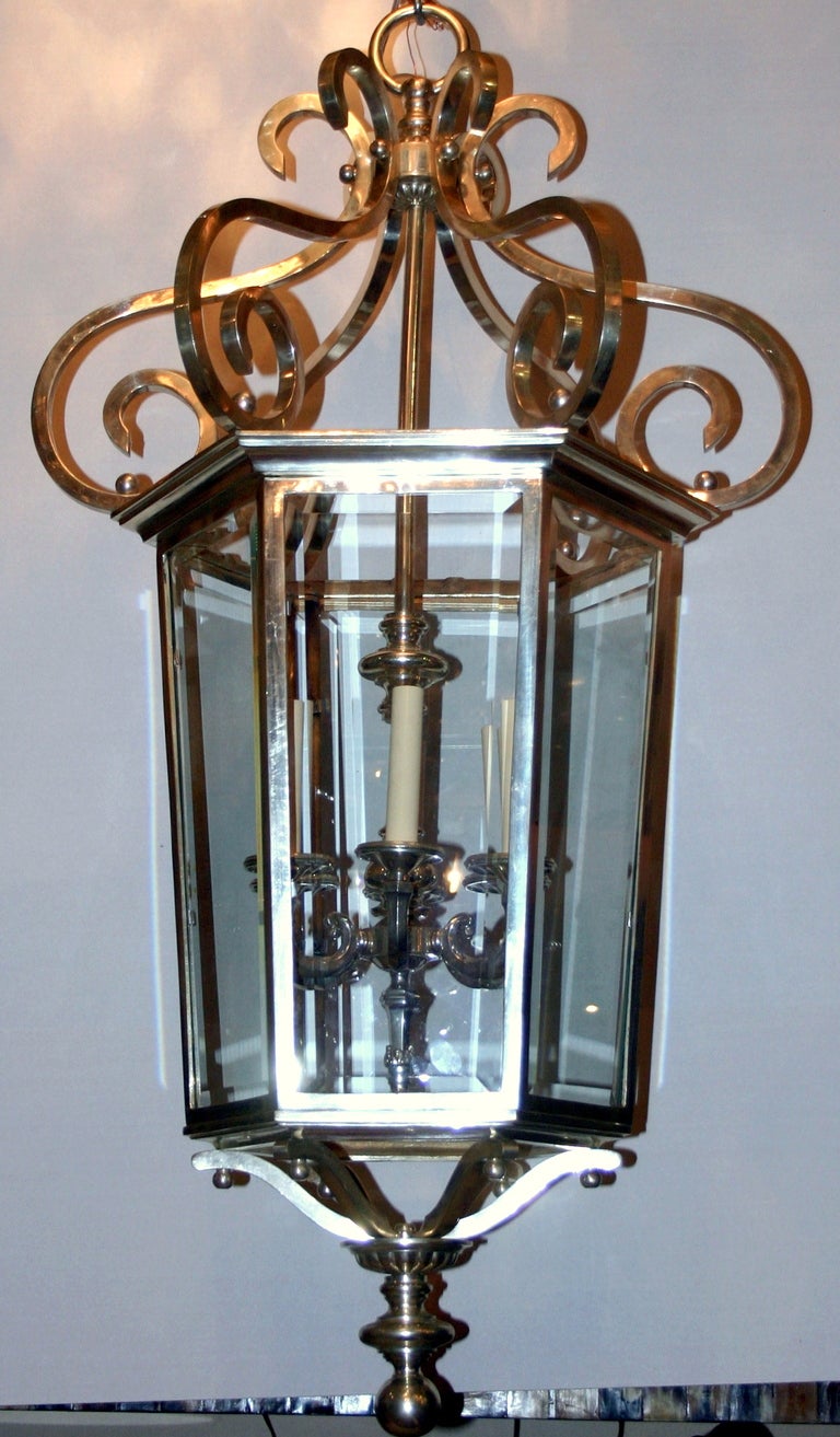 An English circa 940s silver-plated hexagonal lantern with beveled glass panels and six interior lights.

Measurements:
Height: 46.5
