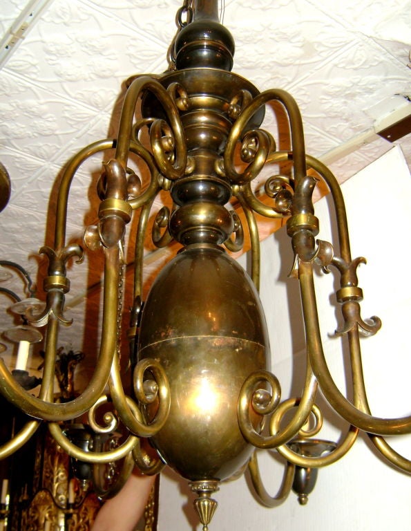 A circa 1900 large patinated bronze chandelier with elongated center body and 6 arms.

Measurements:
Height: 38.5