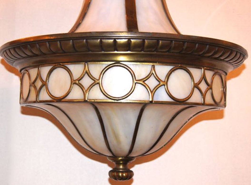 An American leaded glass light fixture with interior lights, circa 1910. Finely cast details.
Measurements:
27" height, 19" diameter.