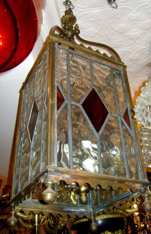 A circa 1900 English bronze and glass lantern with leaded glass insets. 
One small glass panel has a hairline crack but it's complete. 

Measurements:
Height (minimum drop) 37.5