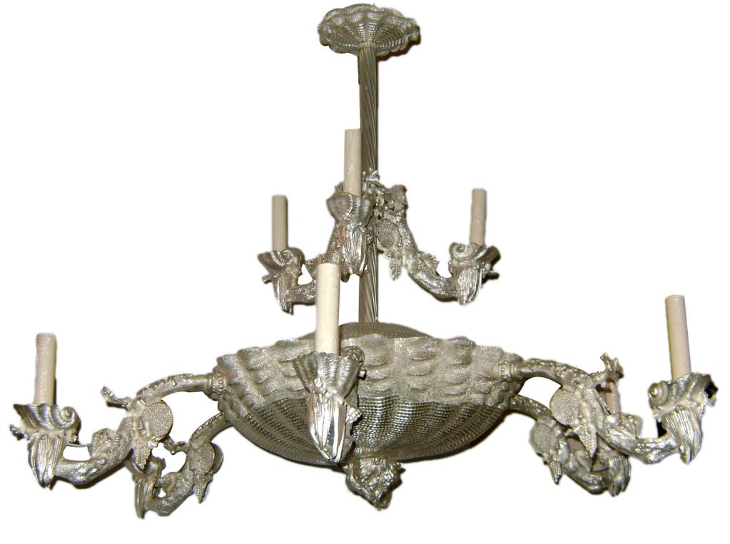 Pair of silver plated French chandeliers with coral and shell motif throughout the body. The centre body in the shape of a large shell. Double tier, the bottom tier with six lights, the top tier with three lights.