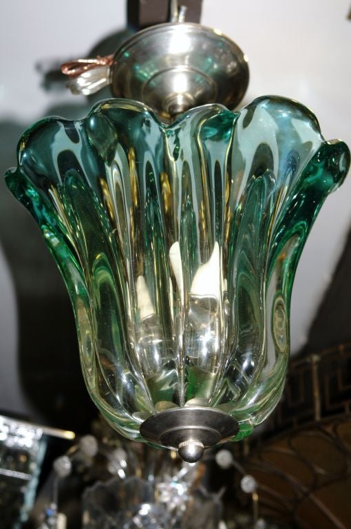 A midcentury Venetian glass pendant light fixture with three interior candelabra lights.

Measurements:
Height (drop) 15
