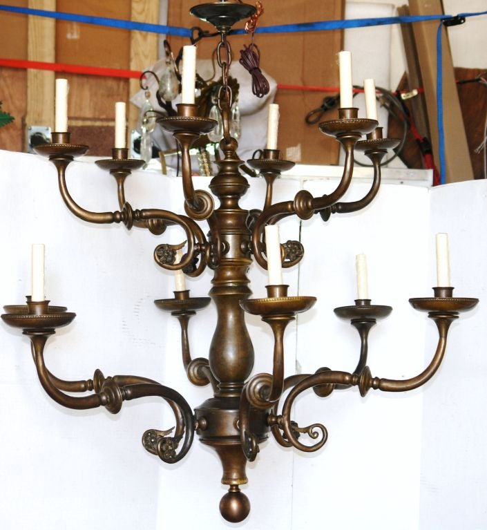 A pair of Dutch, double tiered, patinated bronze chandeliers with 12 lights. Scrolling arms with foliage motif. Very good condition. Original patina. 
Sold Individually

Measurements:
41