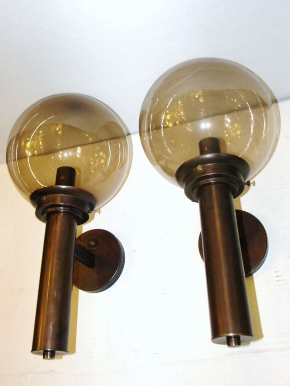 Pair of 1960s Italian sconces with amber glass globes.

Measurements:
Height: 20