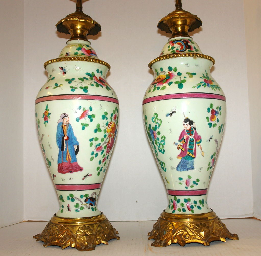 Pair of antique celadon French oil lamps made with Chinese porcelain. Bronze doré bases and bases.
Floral and court scenes.
Measurements:
Height: 22