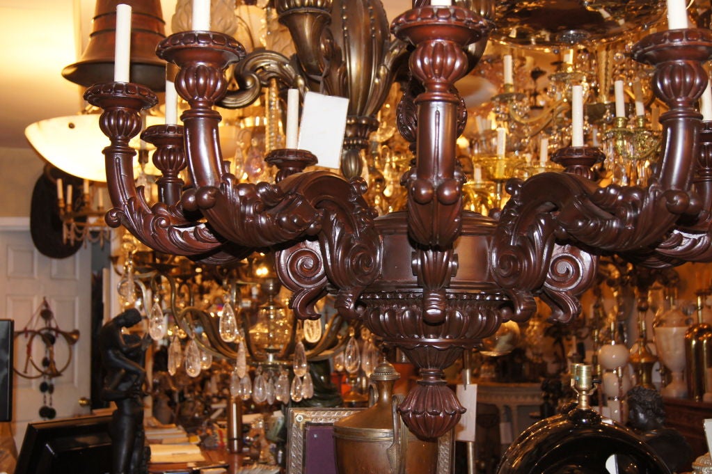 A 1920's Italian carved wood chandelier with scrolling foliage details on body and arms and 10 lights. 

Measurements:
Diameter: 46