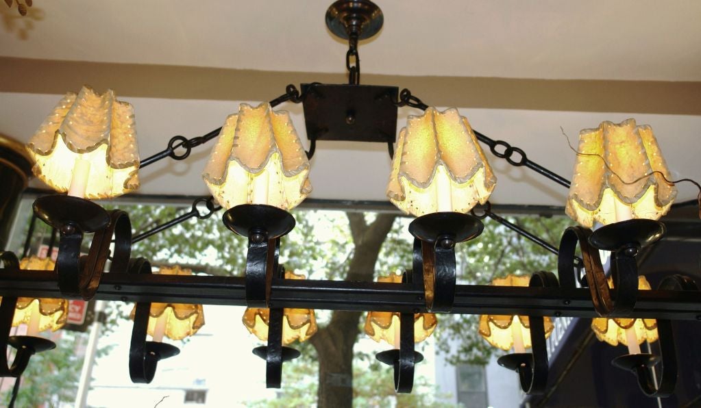 A large circa 1940s Italian wrought iron chandelier with 16 lights.
Italian parchment shades sold separately.