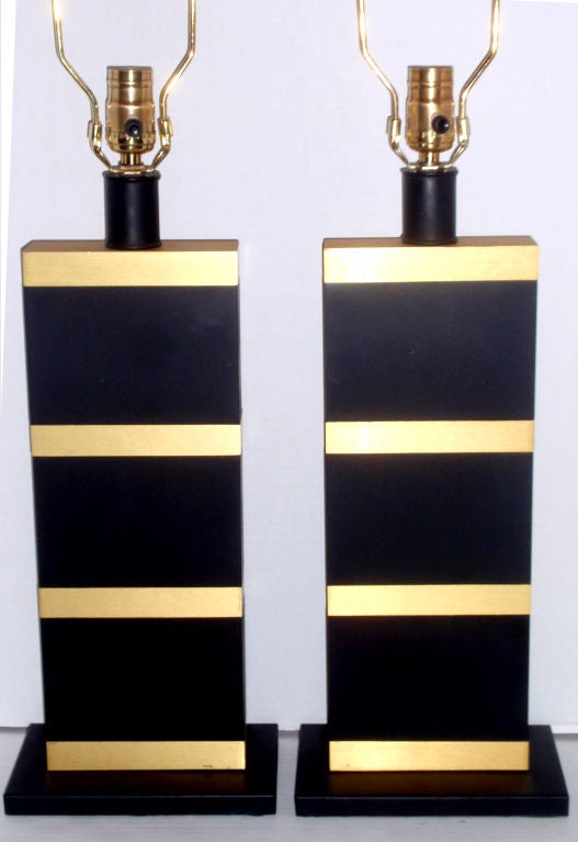 Pair of circa 1960's French metal lamps with black and gilt finish.

Measurements:
Height of body: 17
