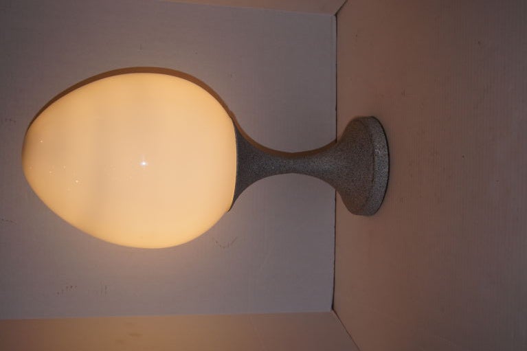Italian, 1960s table lamp with egg shaped shade, interior light. Base with a grey stone faux finish.
Measures: 24