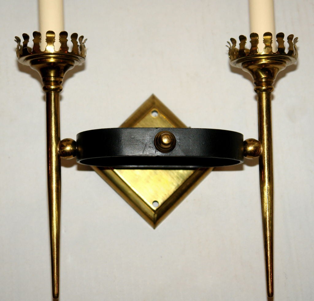 A pair of Italian circa 1950s moderne style sconces with gilt and black finish.
 