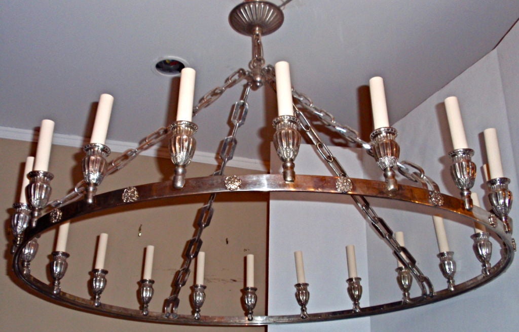 A circa 1920s silver plated neoclassic style chandelier with original finish. 20 lights.

Measurements:
Height 28? drop
Diameter 40?.