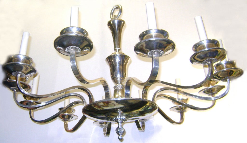 A circa 1920s English silver plated neoclassic style chandelier.

Measurements:
Minimum drop: 27