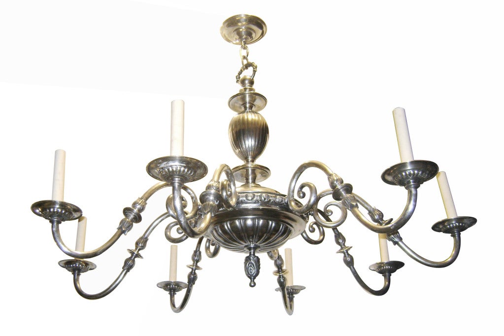 An English 1920s silver plated 8-light neoclassic style chandelier with original finish and patina.

Measurements:
Diameter 40