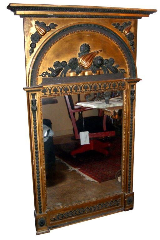 A large 19th century Swedish giltwood Empire period mirror with gilt finish and painted details.

Measurements:
Height: 56