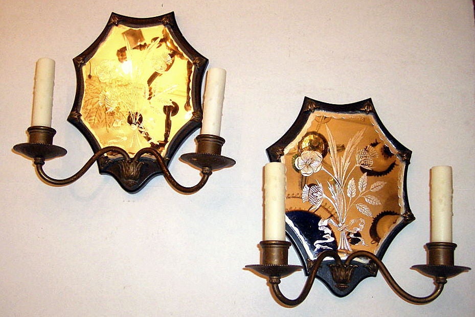 A pair of circa 1920s American 2-arm bronze and etched mirror sconces with floral motif.

Measurements:
Width 12