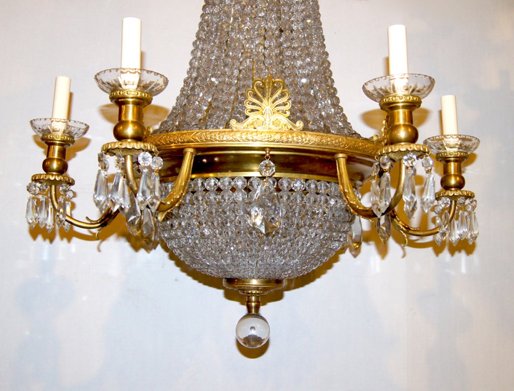 A French 1920's gilt bronze and crystal chandelier with 6 arms and 6 interior lights.

Measurements:
Height: 45.5