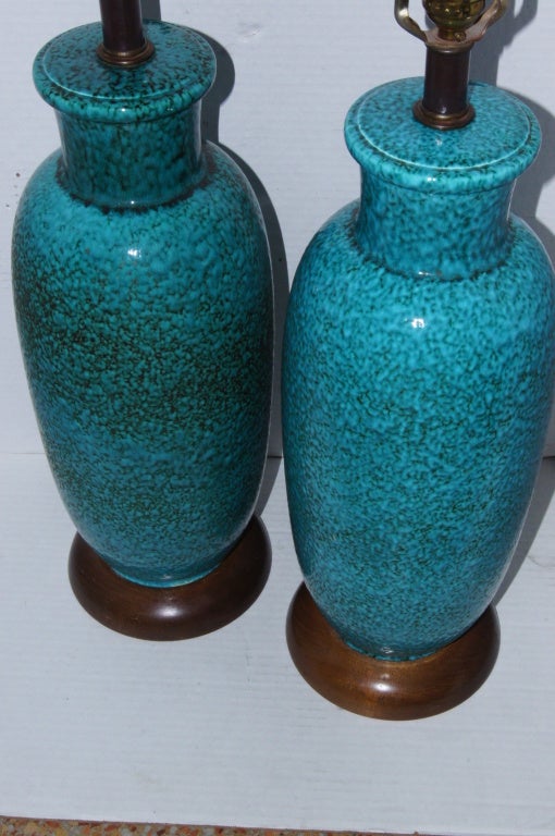 Pair of Italian circa 1930's turquoise colored “ripple” texture ceramic lamps with wooden bases.

Measurements:
Height of body 19.5