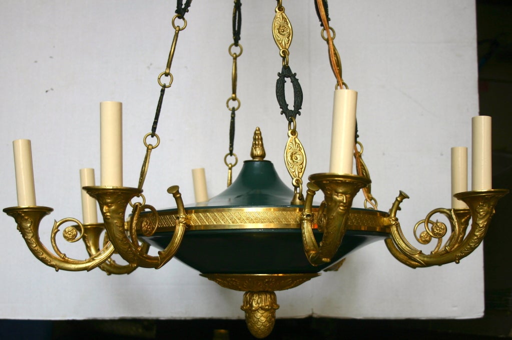 A circa 1930s French gilt bronze Empire style 8-arm chandelier with painted tole body.

Measurements
Current drop: 29
