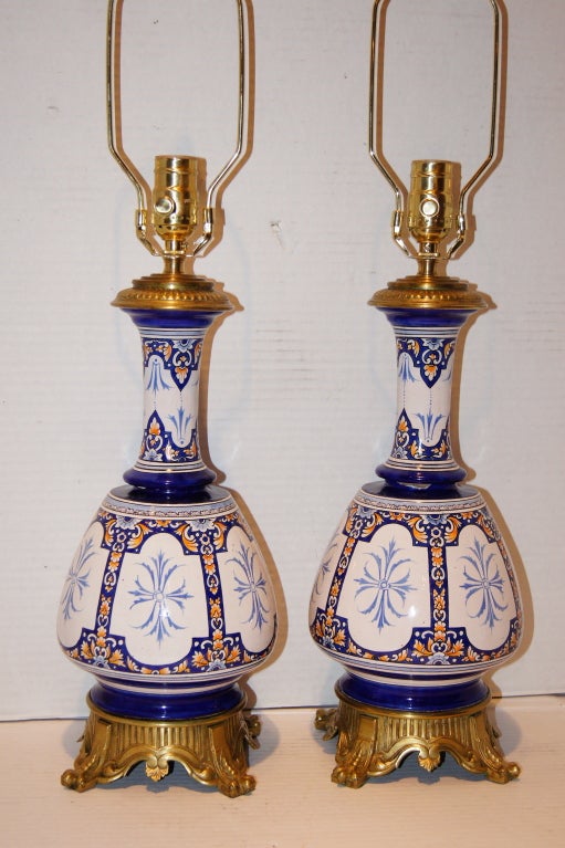 Pair of circa 1900 French porcelain table lamps with gilt bronze bases and hardware.

Measurements:
Height of body: 15.5