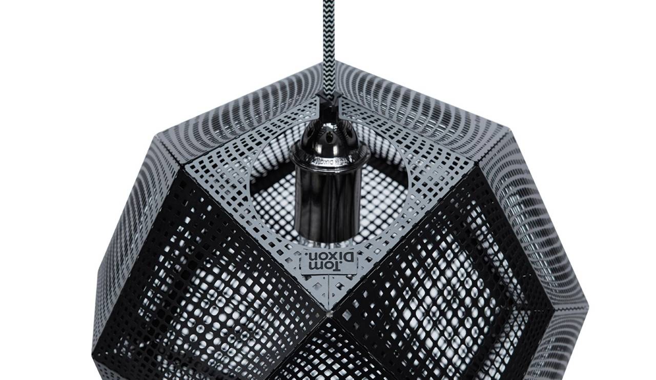A digitally manufactured pendant light etched from metal. Made by employing an industrial process used to produce electronic parts, the method allows for detailed patterns to be cut directly onto the metal, creating a mass of intricate shadows when