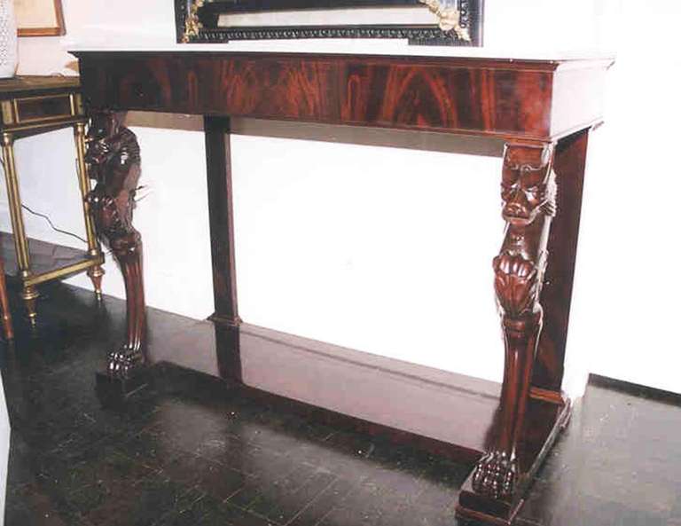 First Empire Italian mahogany console molded white marble top above apron with carved lion monopodial supports shaped plinth base.