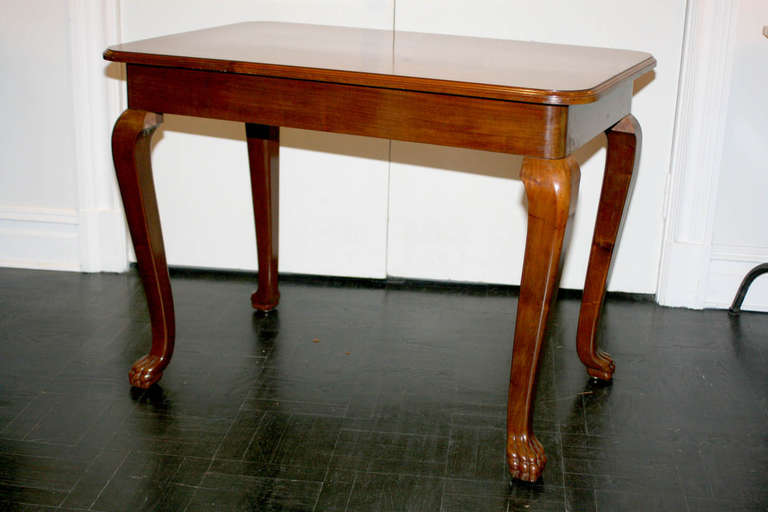 20th century mahogany side table, polished top, cabriole legs ending in paw feet.