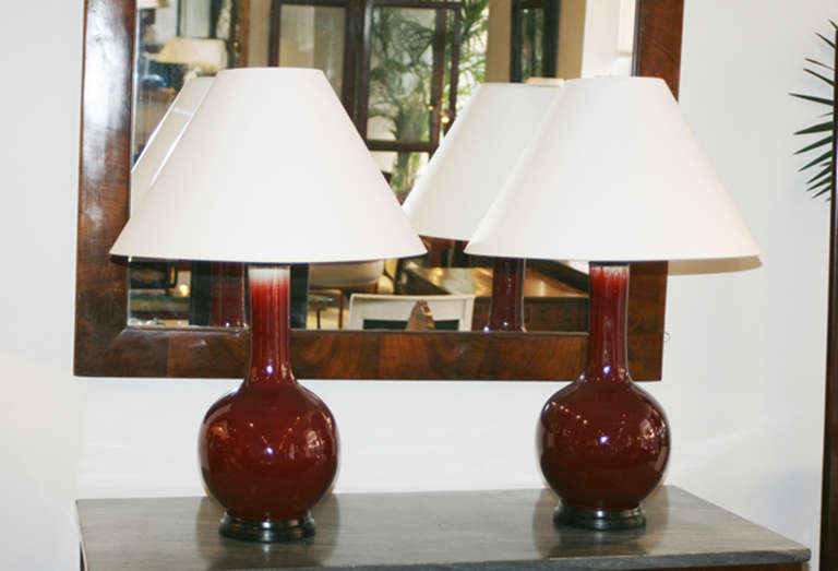 Pair of early 20th Century Sang de Beouf bulb shaped lamps on hardwood bases