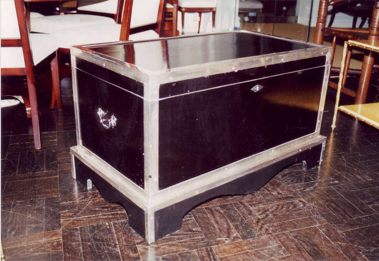 Early 20th century black lacquer and silver plate trunk with drop handles, on stand.