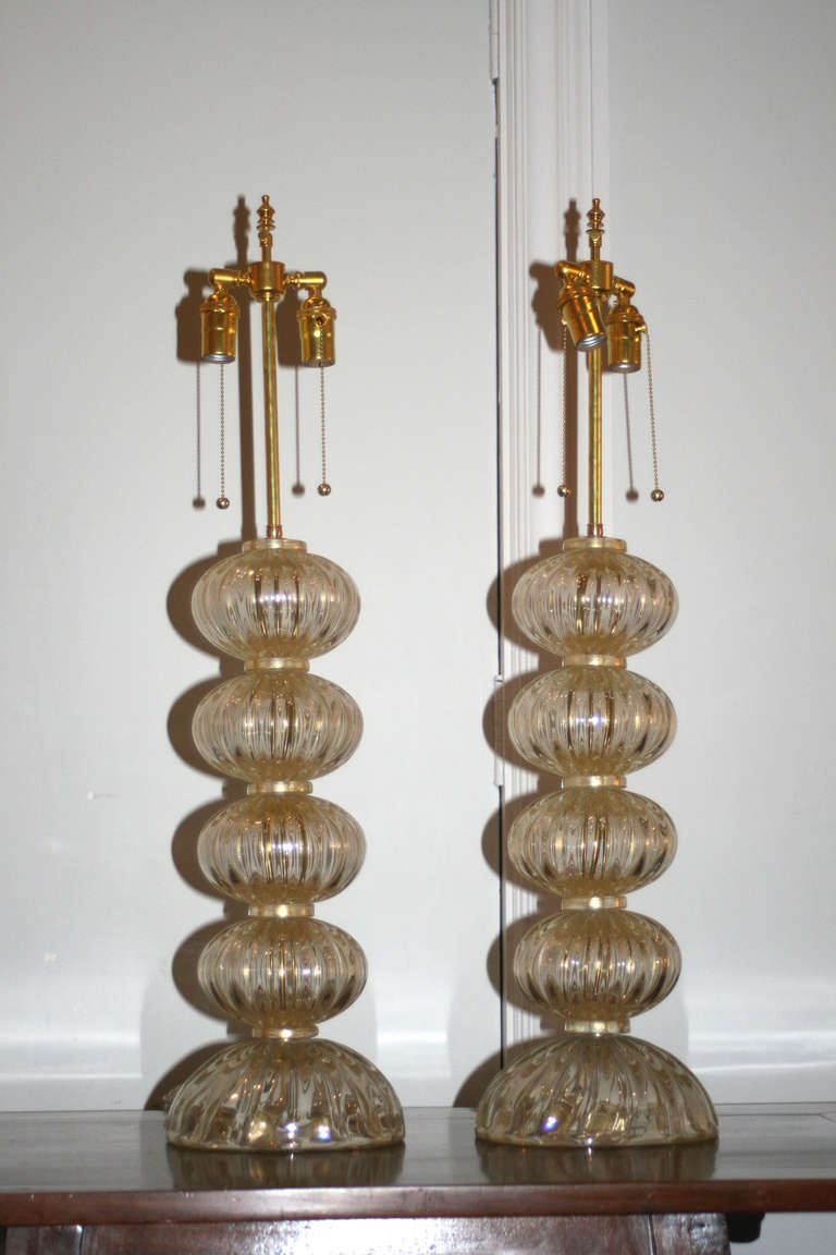 Mid-20th Century pair of Venetian lamps, four ribbed, clear and gold flecked glass spheres on half sphere bases