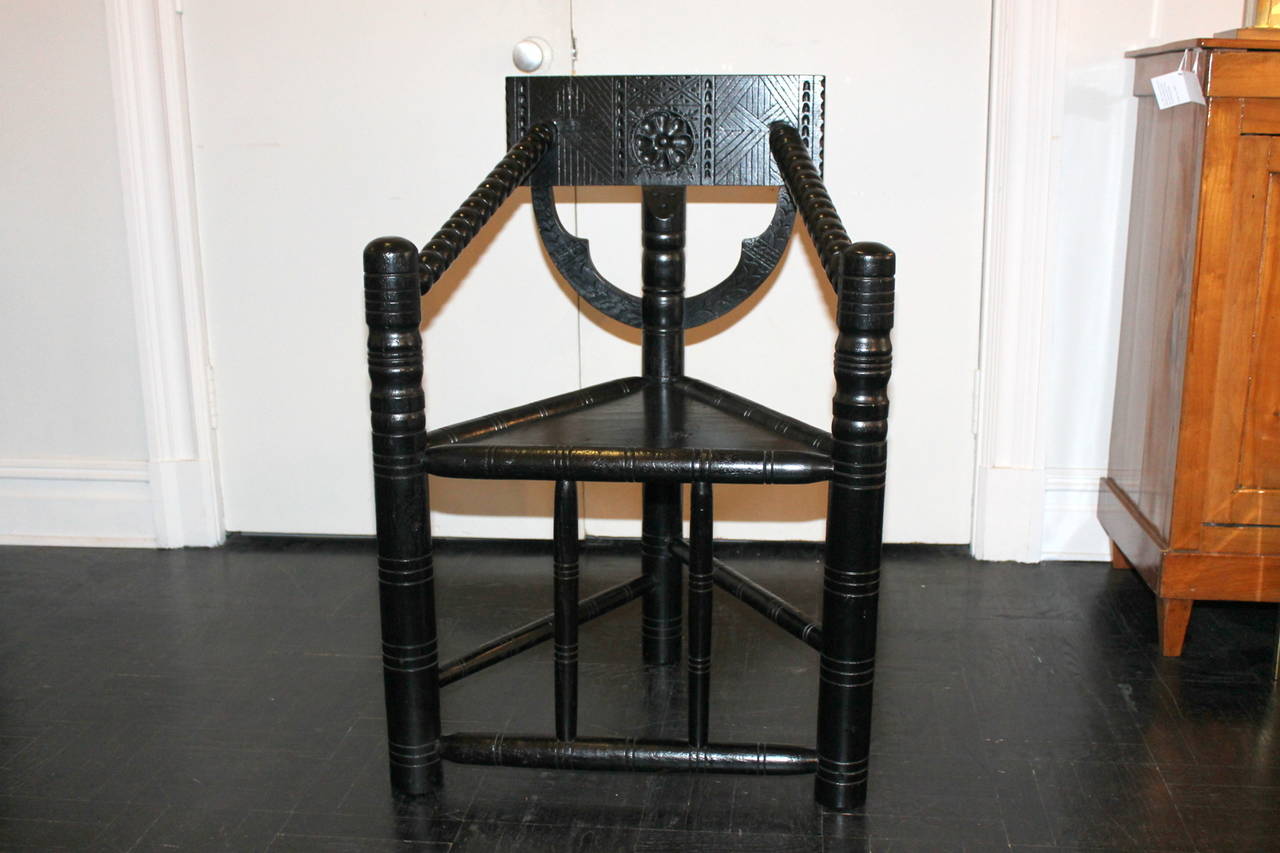 19th Century Turner chair, triangular seat, turned spindle back, arms and apron, later ebonized