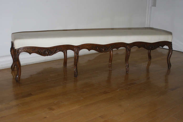 19th century Regency style walnut bench, eight acanthus carved cabriole legs, scrolled feet.