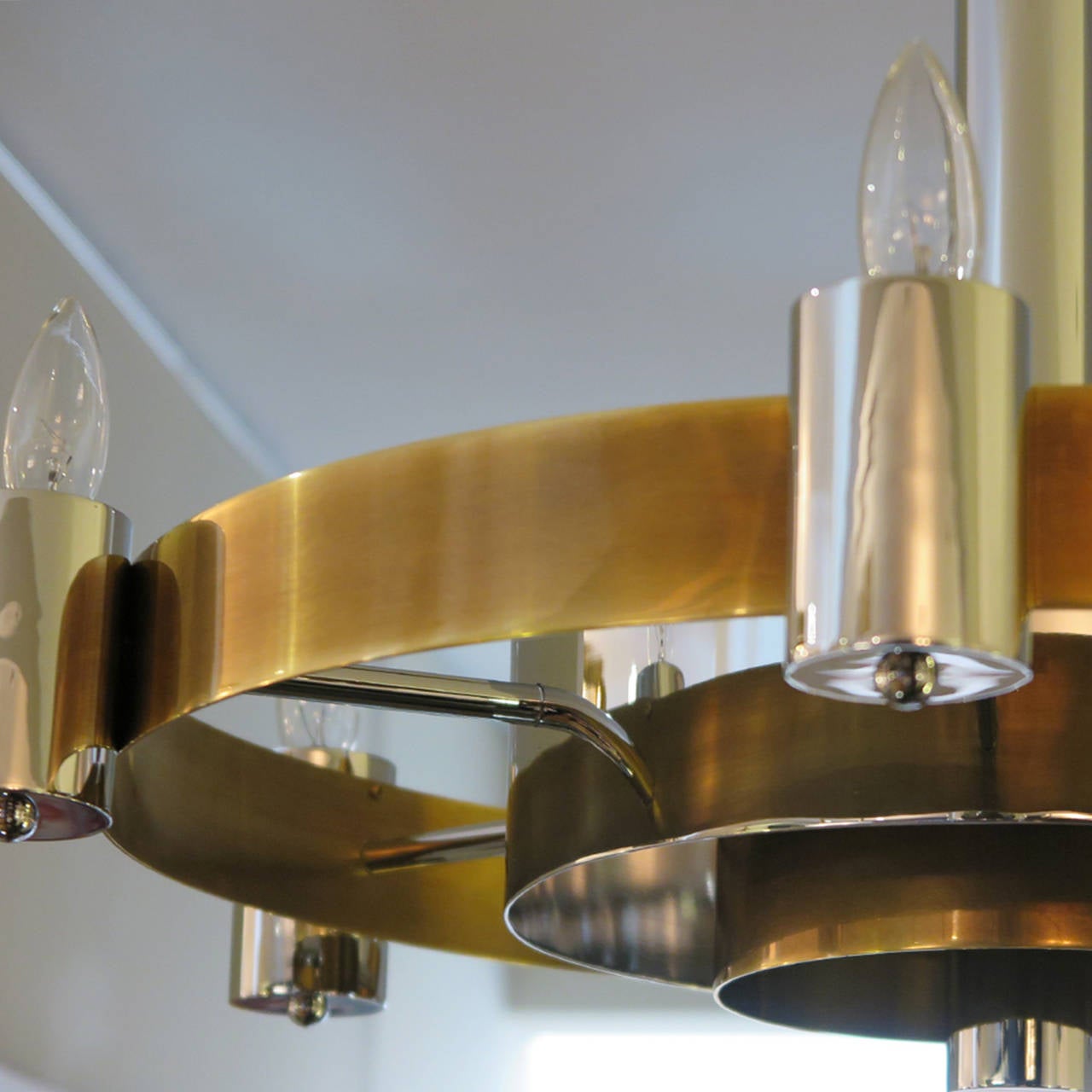 French circular, three-layered chandelier in antique brass and polished nickel. Six candelabra light fittings.