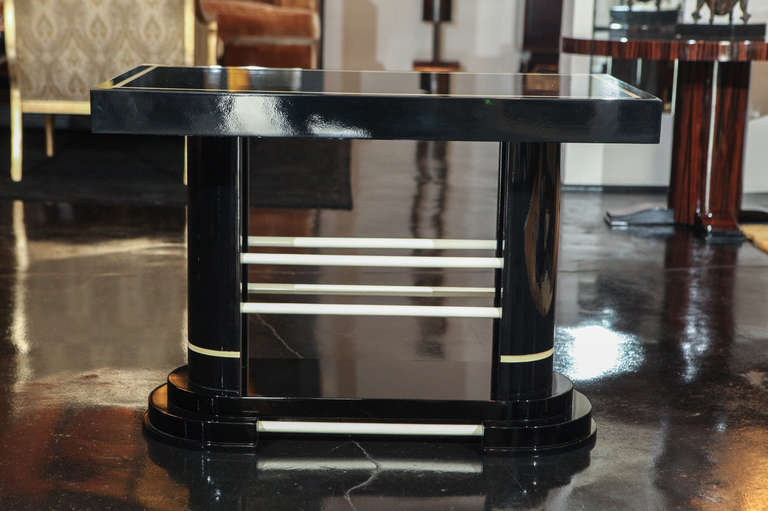 Rectangular Deco-Modernistic side table. Black lacquer with ivory lacquer inlay and details.