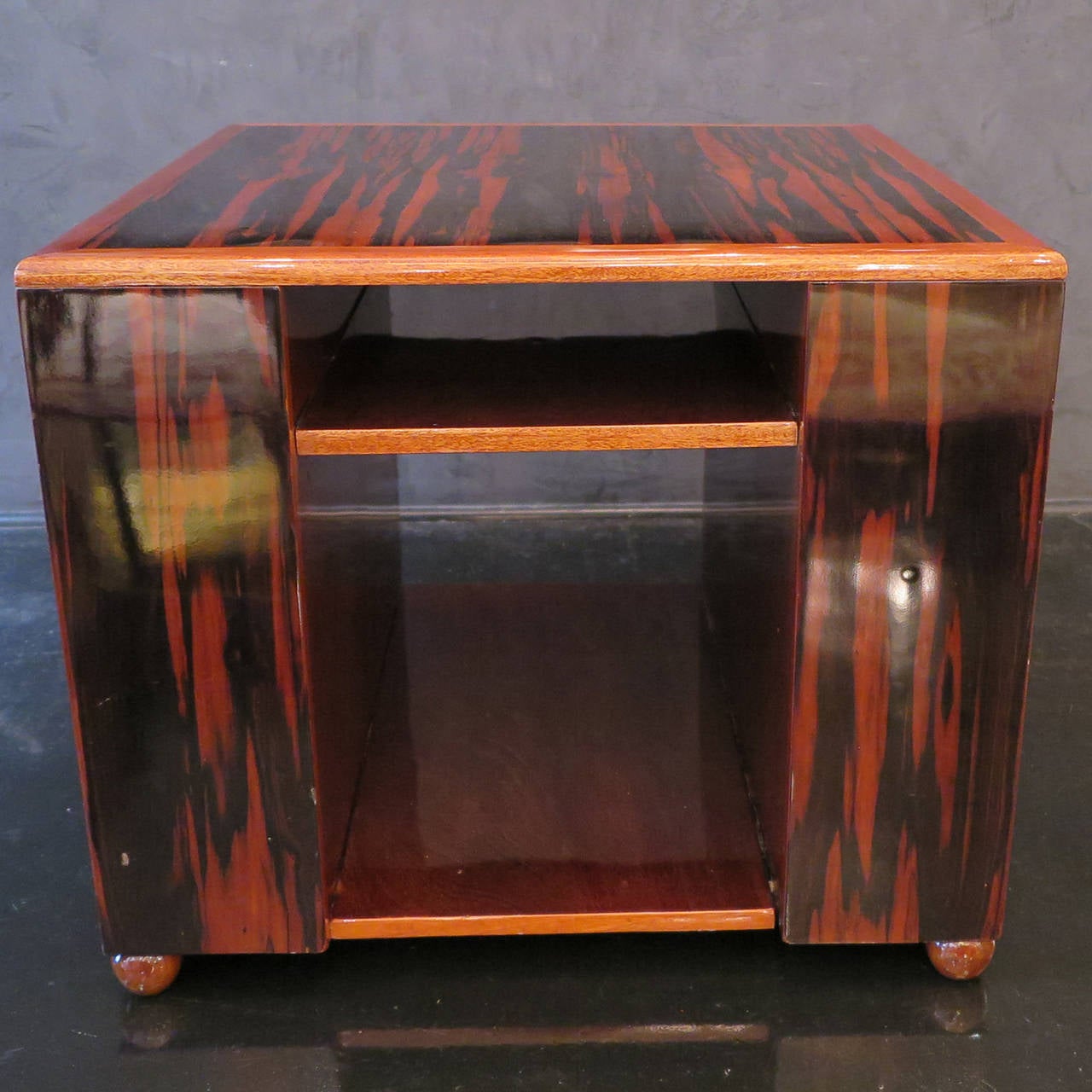 France, 1930's
Coffee or generous side table with inset shelves.  Lacquered Macassar Ebony with Rosewood trim, interior and ball feet.  Quintessential Art Deco.
In Antique Condition.