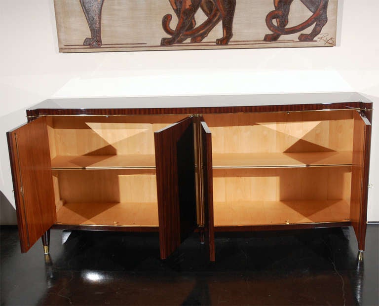 Beautiful original De Coene sideboard from Courtrai, Belgium. Palisander veneer with stunning antique brass detailing framing the piece. In pristine condition, outside as well as inside. Shelving is adjustable. Signed with plaque from De Coene on
