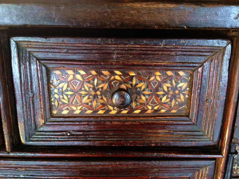 A rare and superbly inlaid late 16th or early 17th century Spanish vargueno. Original iron handles, locks and hardware. Profusely inlaid with bone, pewter and exotic woods. Now resting on a later one drawer walnut stand. Height with stand is 52