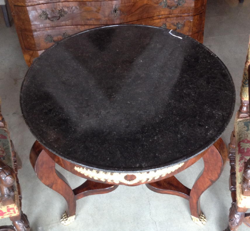 Early 19th century French Empire marble-top gueridon table decorated with gilt bronze mounts and original bronze lion paw feet.