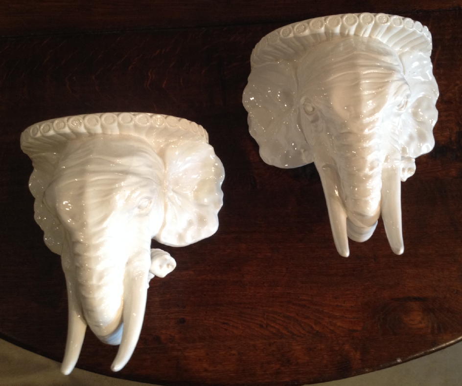 A pair of Mid-Century Italian glazed white pottery elephant wall brackets.