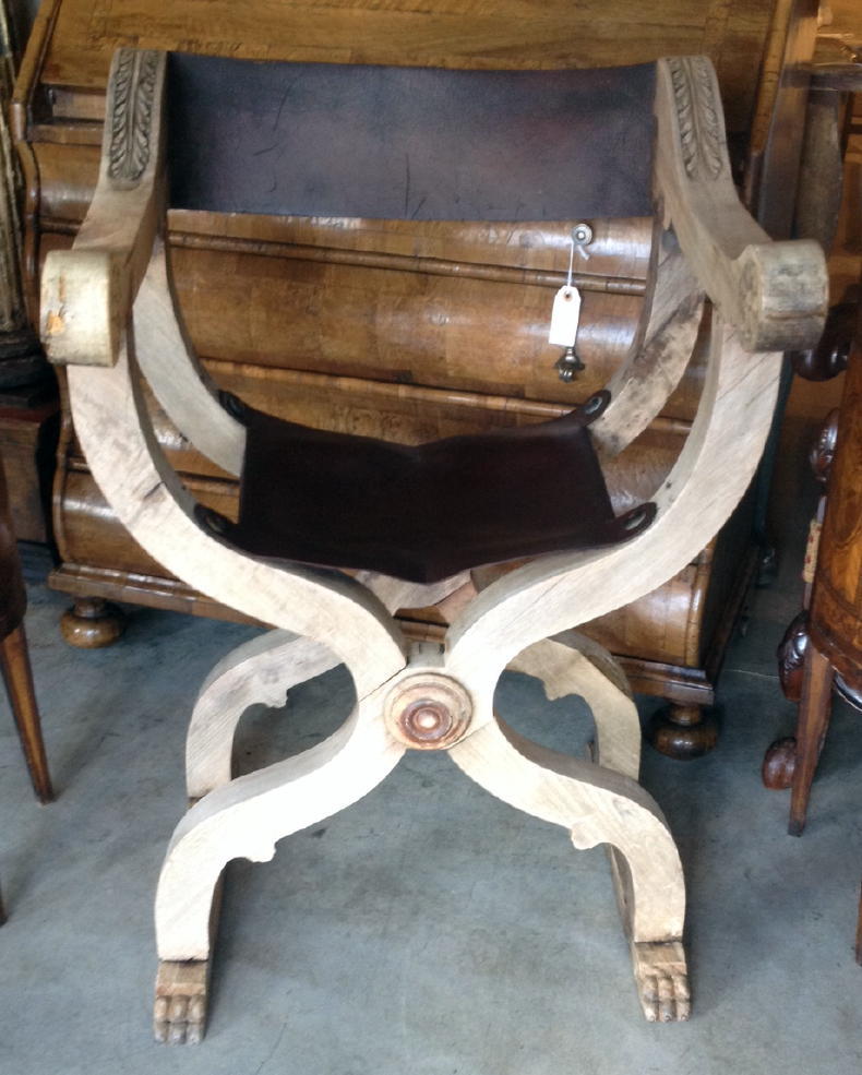 A pair of 19th century Italian Savonarola chairs with leather seats and backs and large brass tacks.