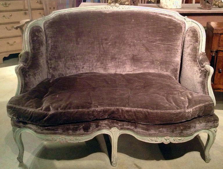A 19th century carved and paint decorated Louis XV style settee. Down filled cushion upholstered in a chocolate mohair fabric.