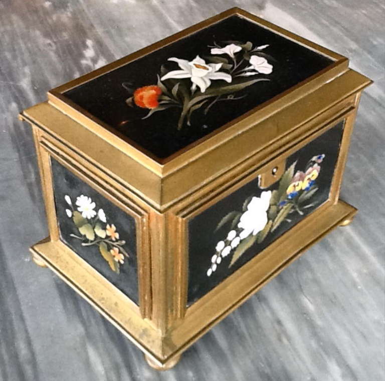 An Italian Grand Tour Gilt Bronze Box Mounted With Five Square Pietra Dura Plaques, The Hinged Top Similarly Mounted The Bottom Lined In Velvet. Marked Florence On The Bottom.