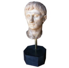 A CARVED MARBLE BUST OF CAESAR