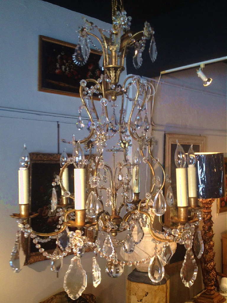 A Mid 20th Century Beaded Crystal Chandelier With A Gold Gilt Iron Frame.