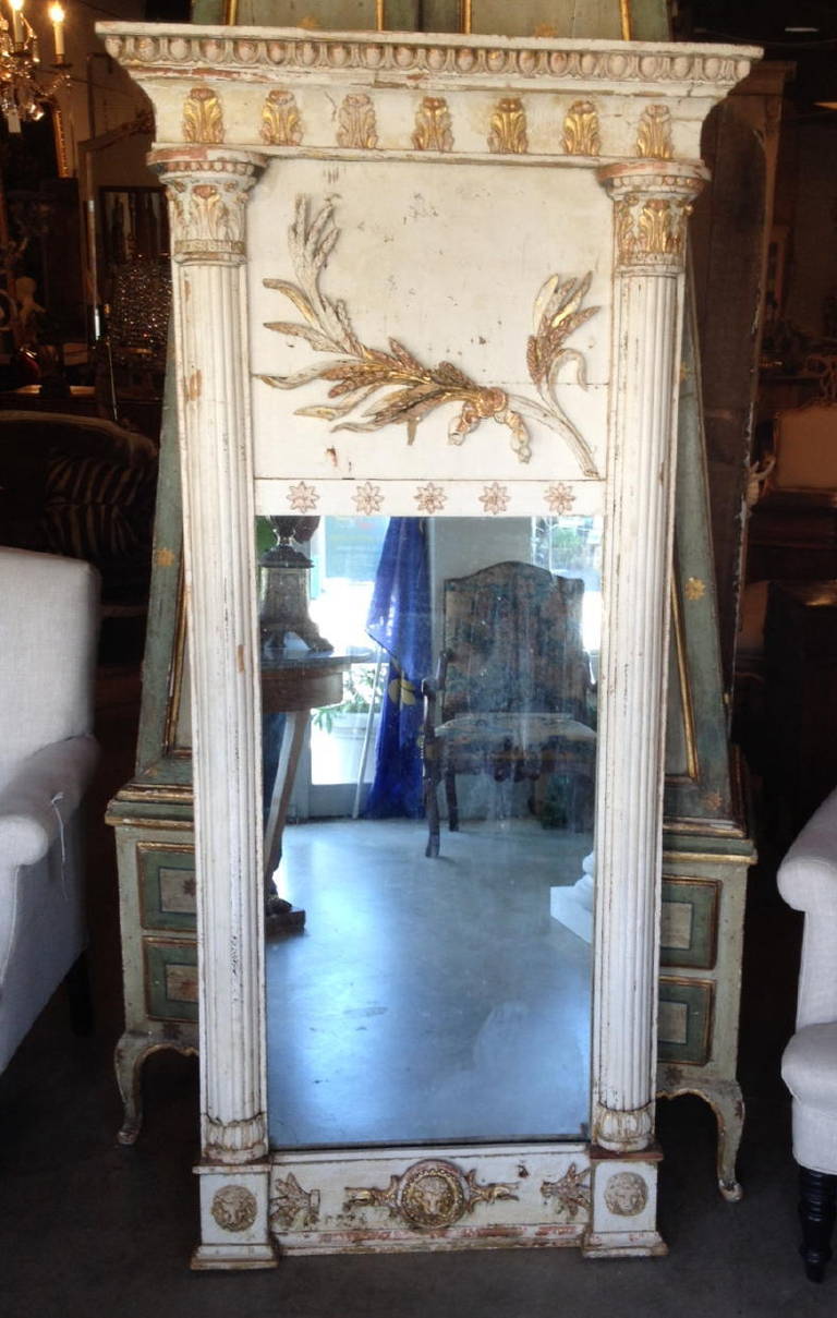 19th century French mirror carved and decorated with lion heads and stars. Fluted columns on either side. Wonderful old remnants of gilt and painted gesso. Great patina.