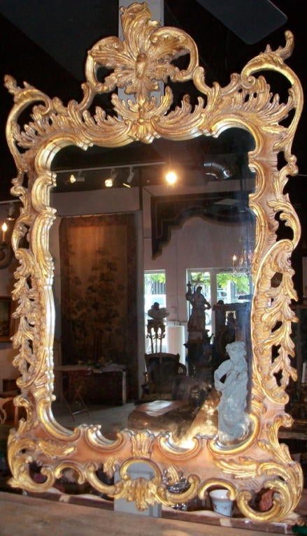 A Carved and Gilt Wood Rococco Style Mirror.