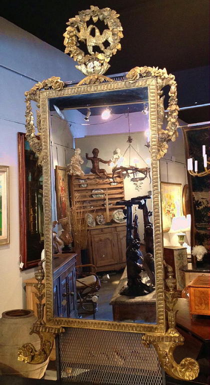 A carved and giltwood late 18th century Italian Neoclassic mirror.