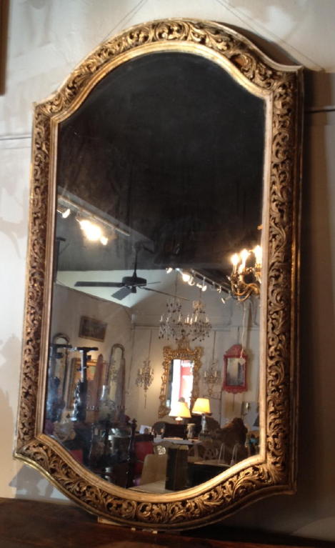 A very large 19th century profusely carved and gilt wood framed mirror.
